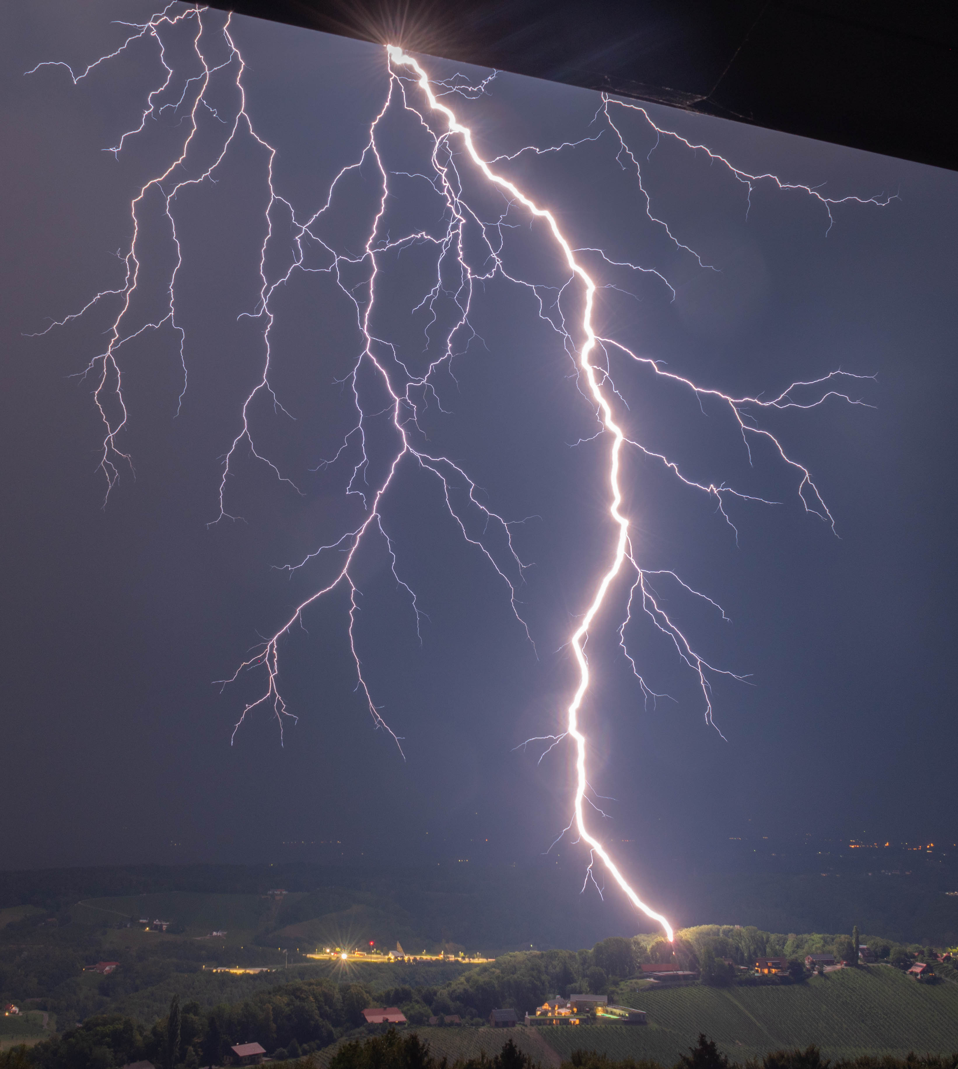 Lightning strike over hills near Plački Stolp, Slovenia — storm photography by Amadej Krepek